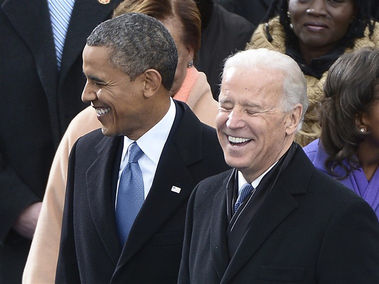 बिडेन shares a laugh with President Obama during the inauguration ceremony on the West Front of the US Capitol before Obama is ceremonially sworn in for a second term as the 44th President of the United States.