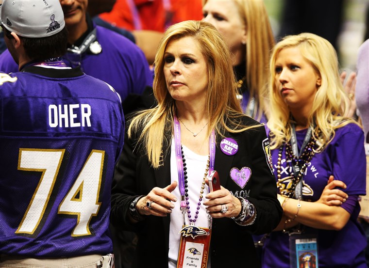 ליי Anne Tuohy celebrates on the field after her adoptive son Michael Oher and the Ravens won the Super Bowl.