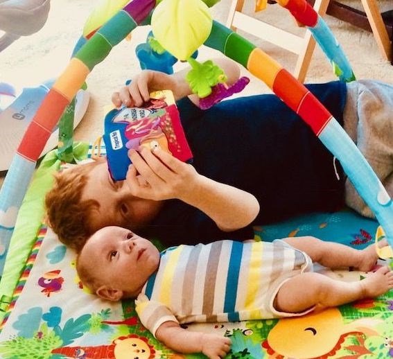 मिकी loves to sing and read books to his baby brother.