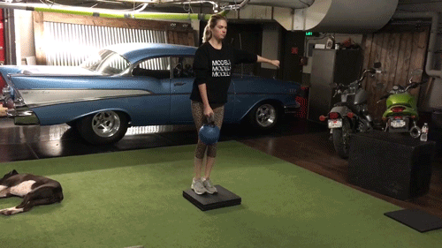 קייט Upton demonstrates how to do a reverse lunge with a weight.