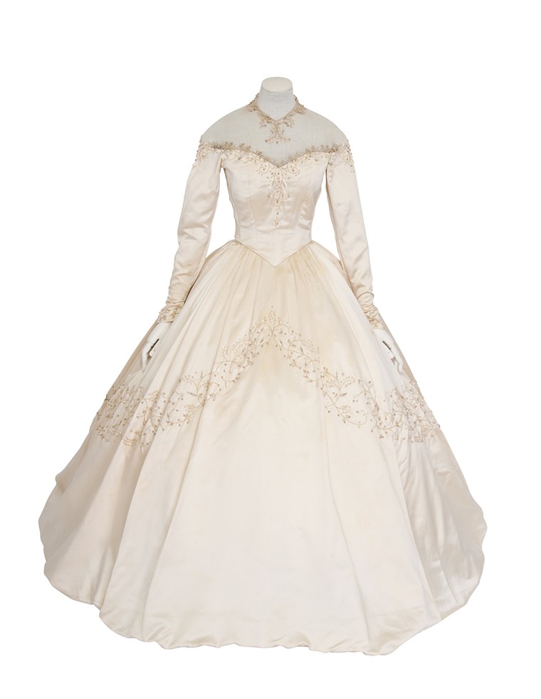 ה gown Elizabeth Taylor wore for her first wedding was auctioned off Wednesday for more than twice than the highest estimate. 