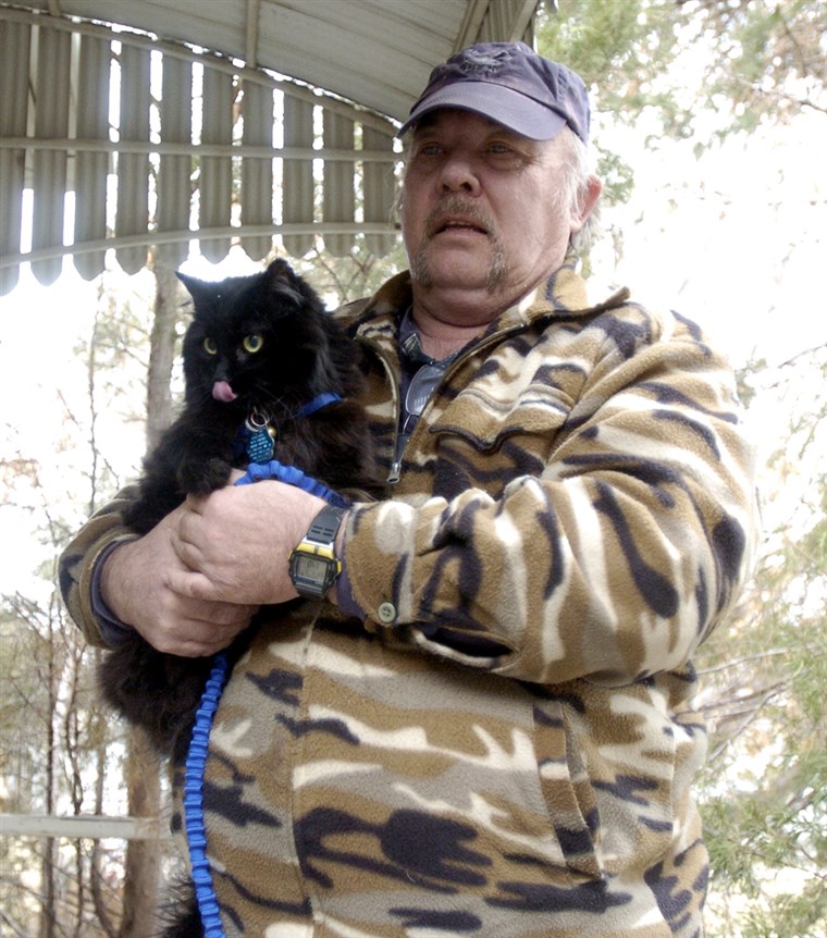 גרג Guy holds Schnautzie the cat.