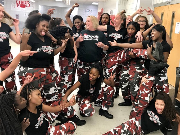 jezero Mary High School principal Dr. Mickey Reynolds poses with members of the school's step team after their surprise pep rally performance.