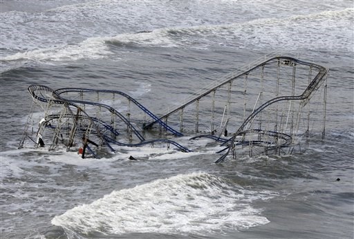 U this Wednesday, Oct. 31, 2012 file photo, waves wash over a roller coaster from a Seaside Heights, N.J. amusement park that fell in the Atlantic