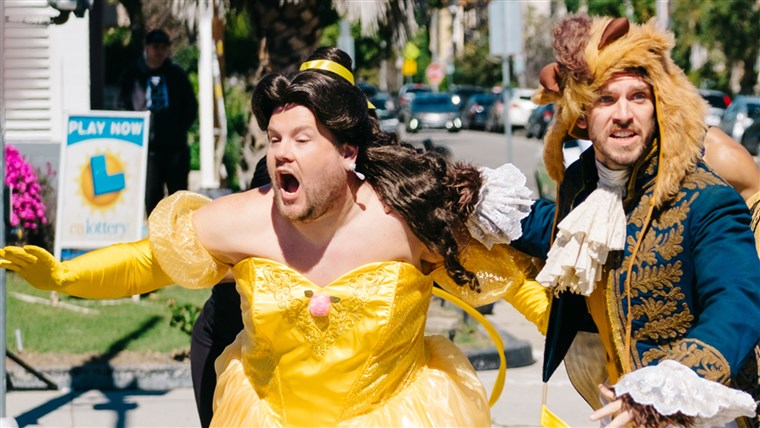 Corden makes a mad dash out of the street while dressed in his Belle costume. 