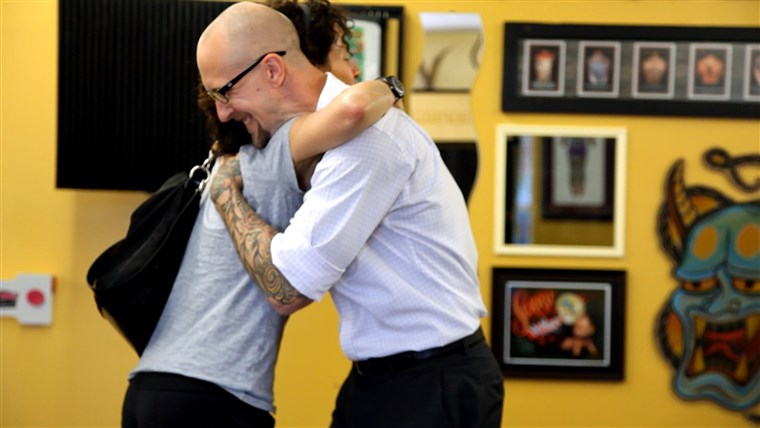 टैटू artist Trent Wyczawski hugs nipple tattoo client Adrienne Peres