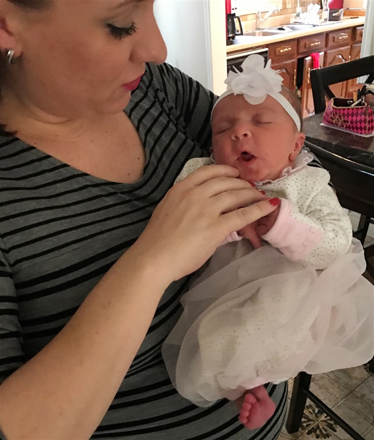 אמא who wore Chewbacca mask during labor holds her new daughter
