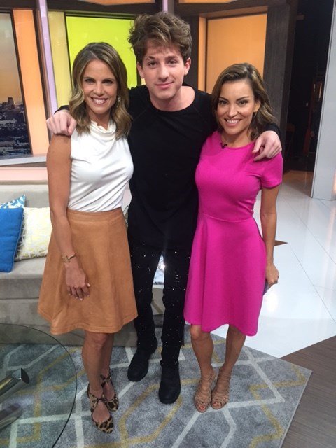 Natalie Morales and Kit Hoover chat with Charlie Puth on set.