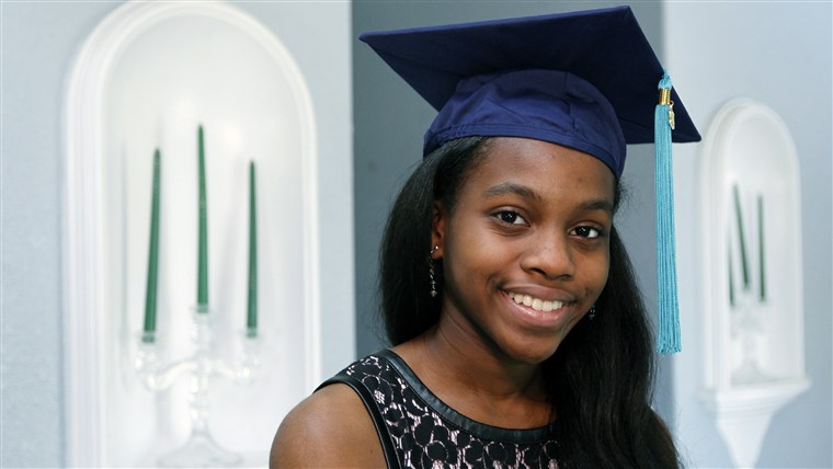 Kegyelem Bush poses in her university graduation cap.