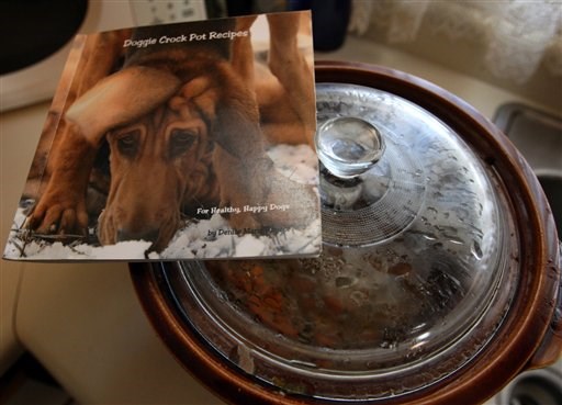 ए cookbook of recipes for pets by Denise Rayzor of Palisade, Colo. is seen in this Jan. 20, 2012 photo. As people are getting choosier about what they eat, they’re insisting on providing their pets with more nutritious foods. (AP Photo/The Daily Sentinel, Dean Humphrey) MANDATORY CREDIT
