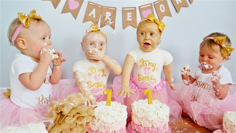 An amateur baker has created life-size cake versions of her twin daughters to celebrate their first birthday. 