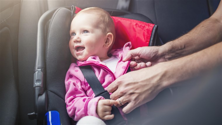 קטן baby girl in a car in a child seat