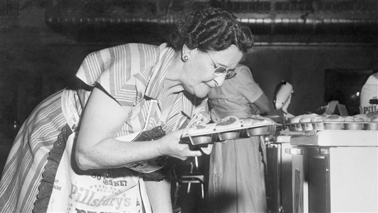  participant pulls her 80 minute bicuits fresh out the oven during the 1949 bake-off.