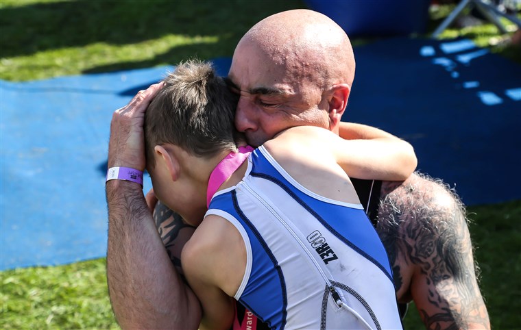 bejli Matthews, 8-year-old with cerebral palsy who finished a triathalon, celebrating at the finish line