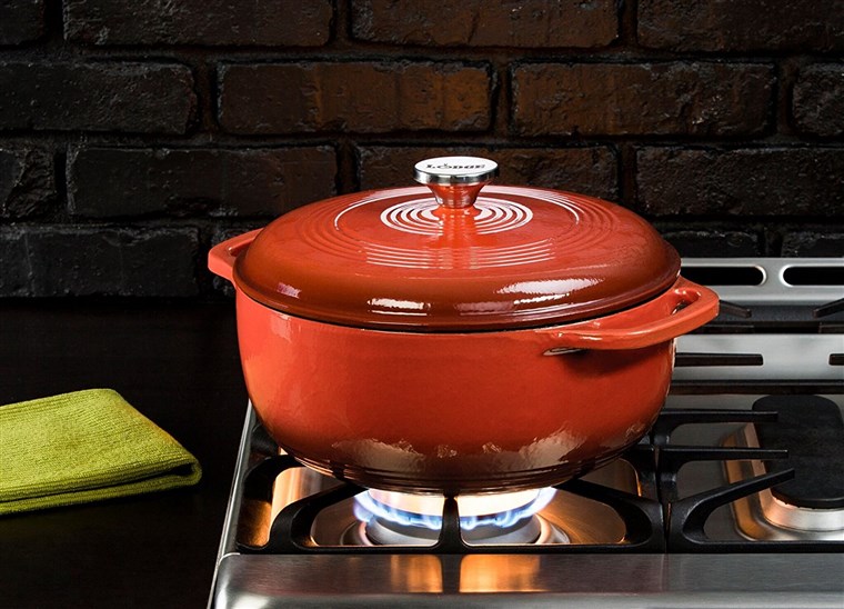 लॉज dutch oven in red on Stove
