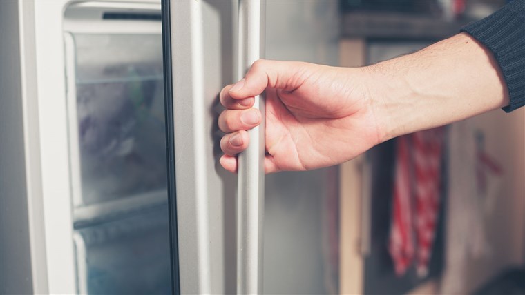 יד opening freezer door