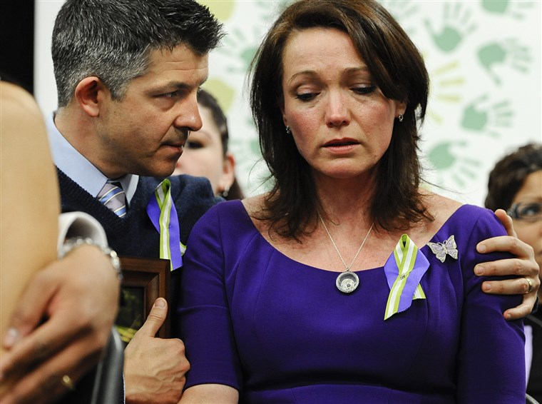 इयान and Nicole Hockley, parents of Sandy Hook School shooting victim Dylan, listen at a news conference at Edmond Town Hall in Newtown, Conn., Monday,...