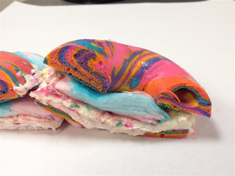 Kereszt Section of Rainbow Bagel Stuffed with Funfetti Cream Cheese and Cotton Candy from Brooklyn's The Bagel Store